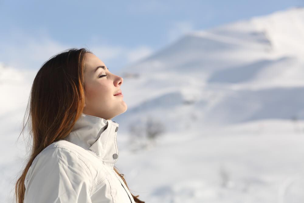 Woman breathing fresh winter air