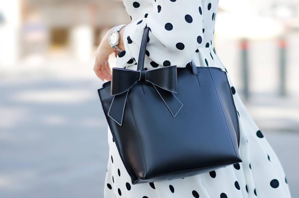 Woman with handbag and polka dot dress