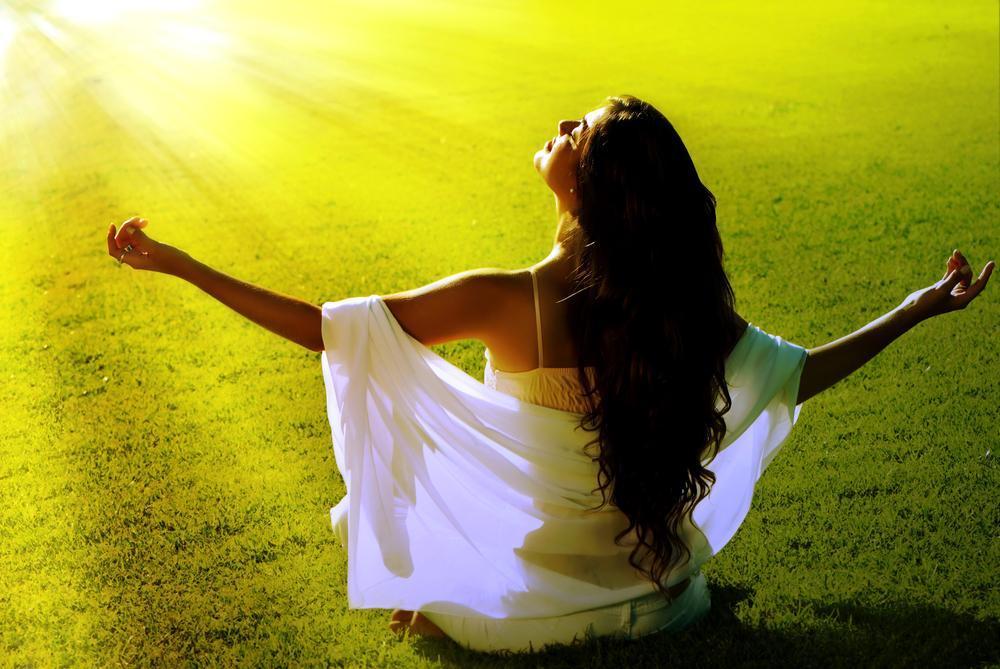Woman meditates in sun