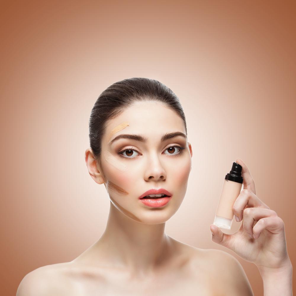 Woman holding foundation with contoured makup