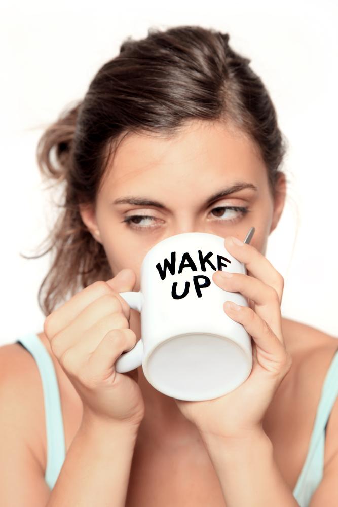 Tired woman sips coffee