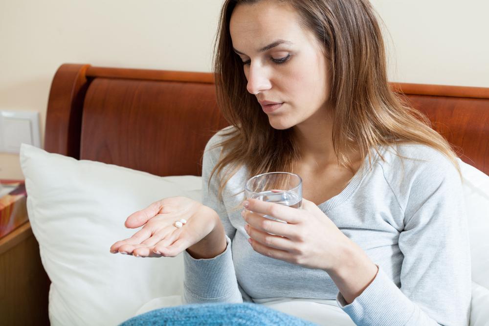 woman taking pill