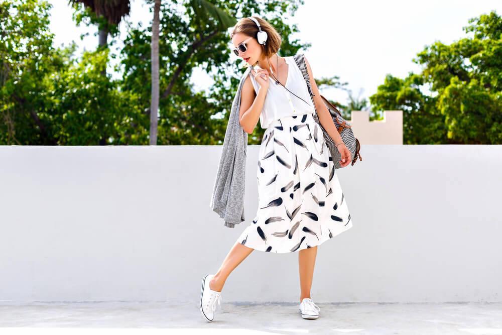 Young woman in white flowing summer skirt and blouse