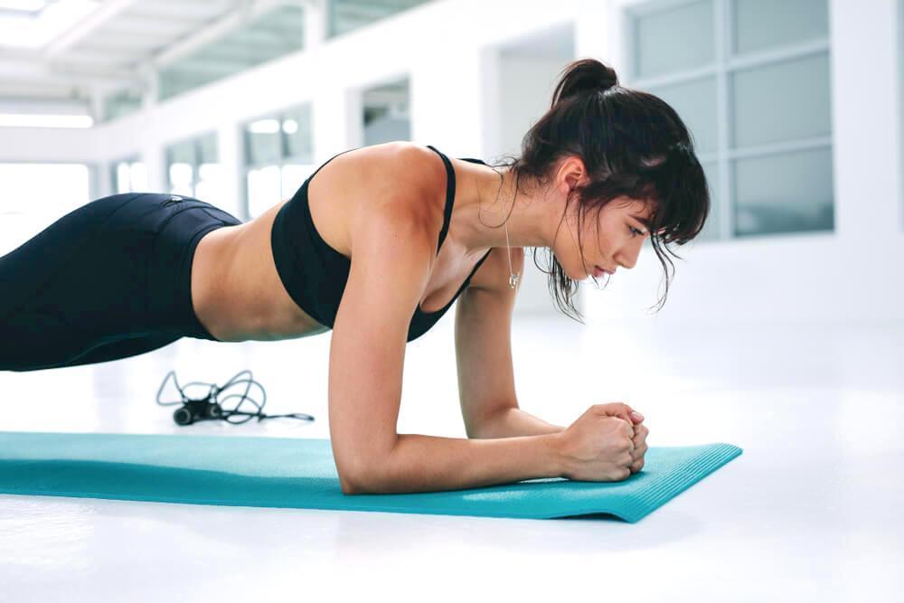 Young athletic woman doing the plank
