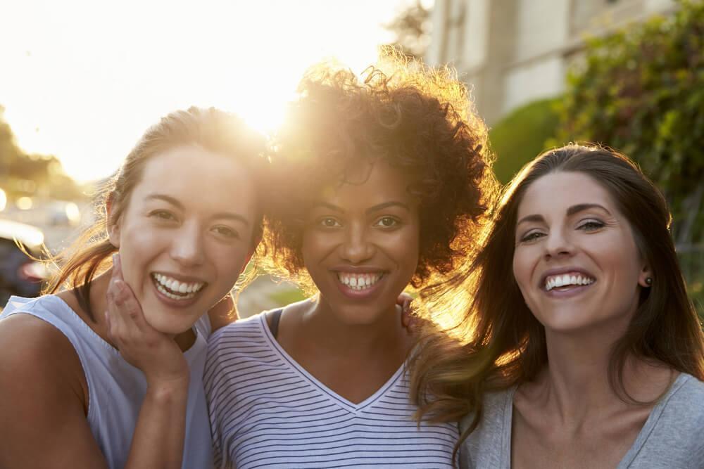 Three friends smiling 