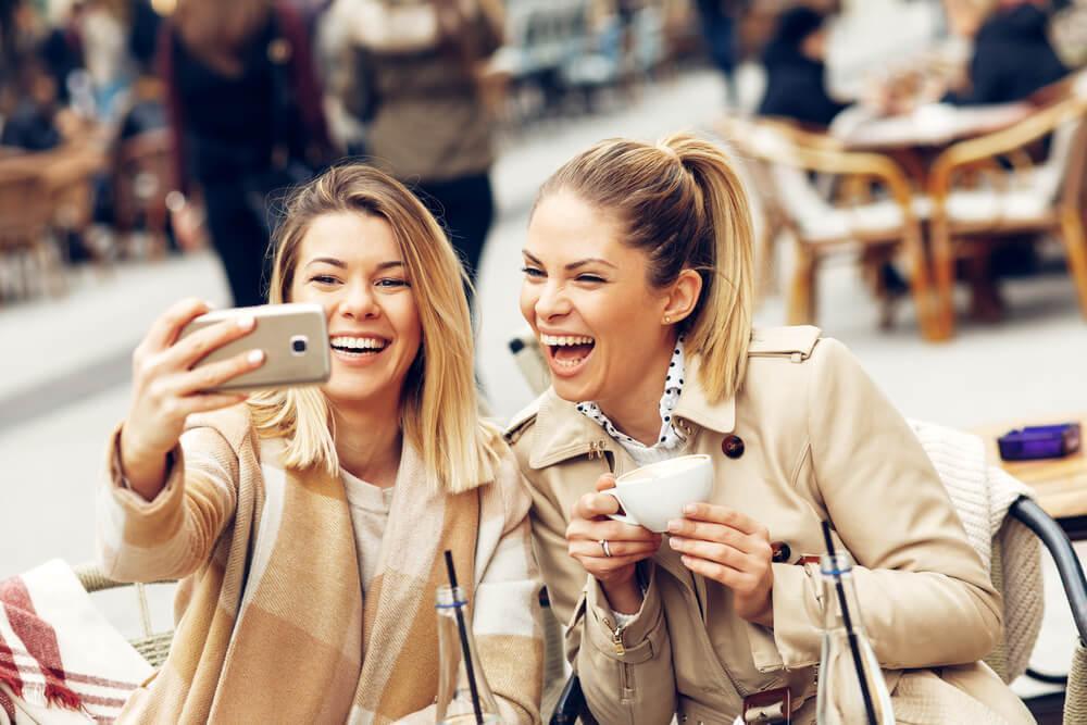 Friends taking a selfie over coffee