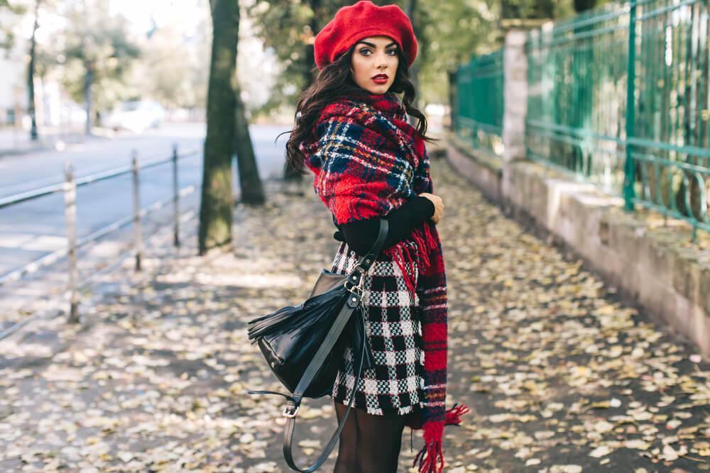 Fashionable woman in red beret and scarf in the street