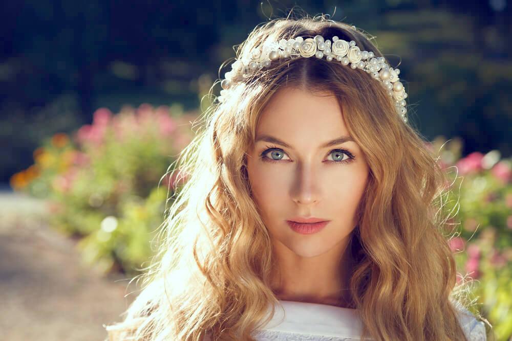Pretty young woman with floral garland on hair