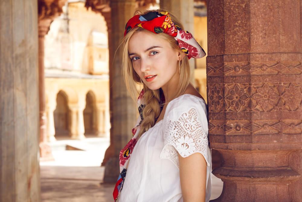 Pretty young woman with red scarf in braided hair 