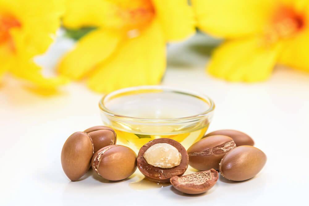 Bowl of argan oil, with argan nuts