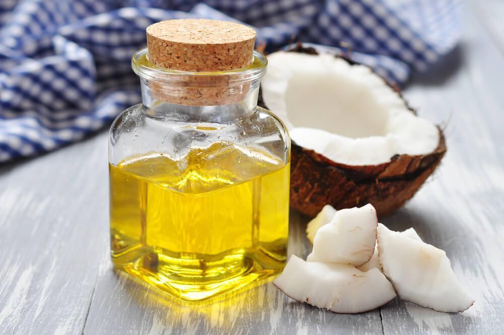 Coconut oil in a jar, with halved coconut 