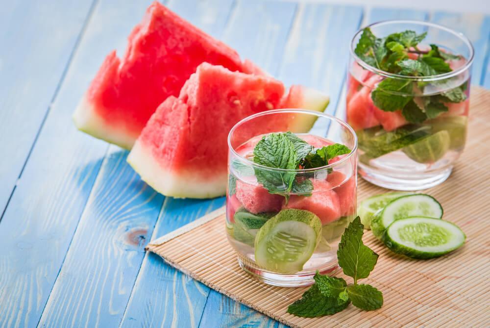 Glasses of water infused with watermelon, cucumber and mint