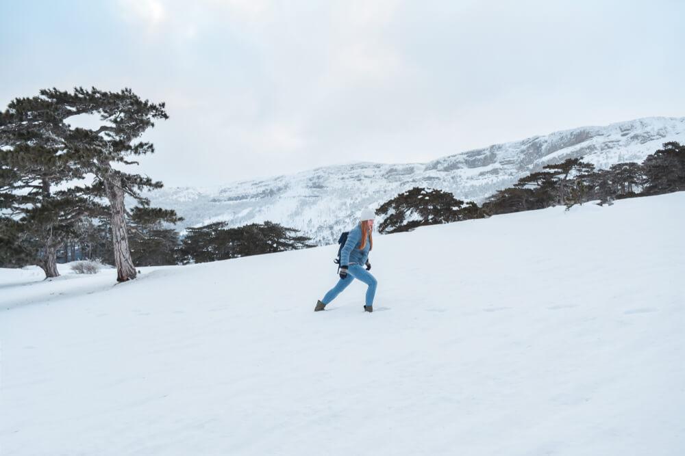 Woman hiking in snow