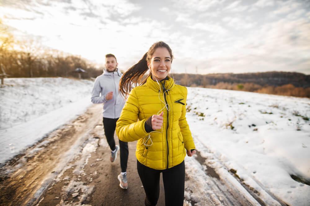 Man and woman running in snow