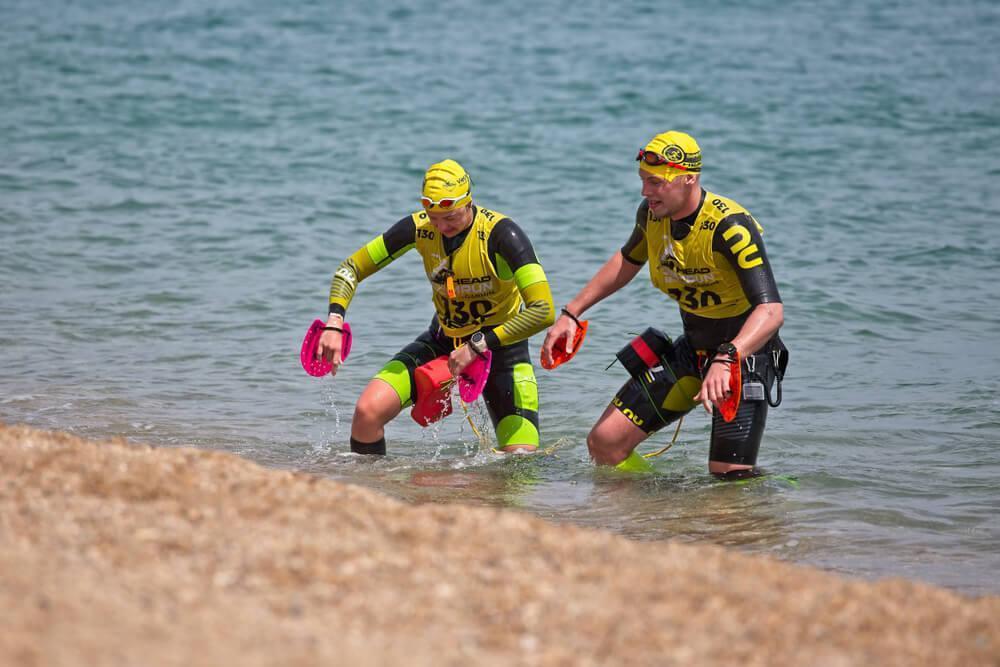 Swimrun competition with two men coming out of the water