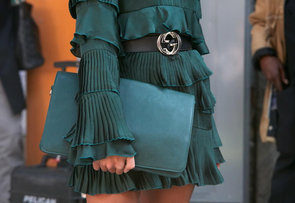 Close-up view of green dress and purse
