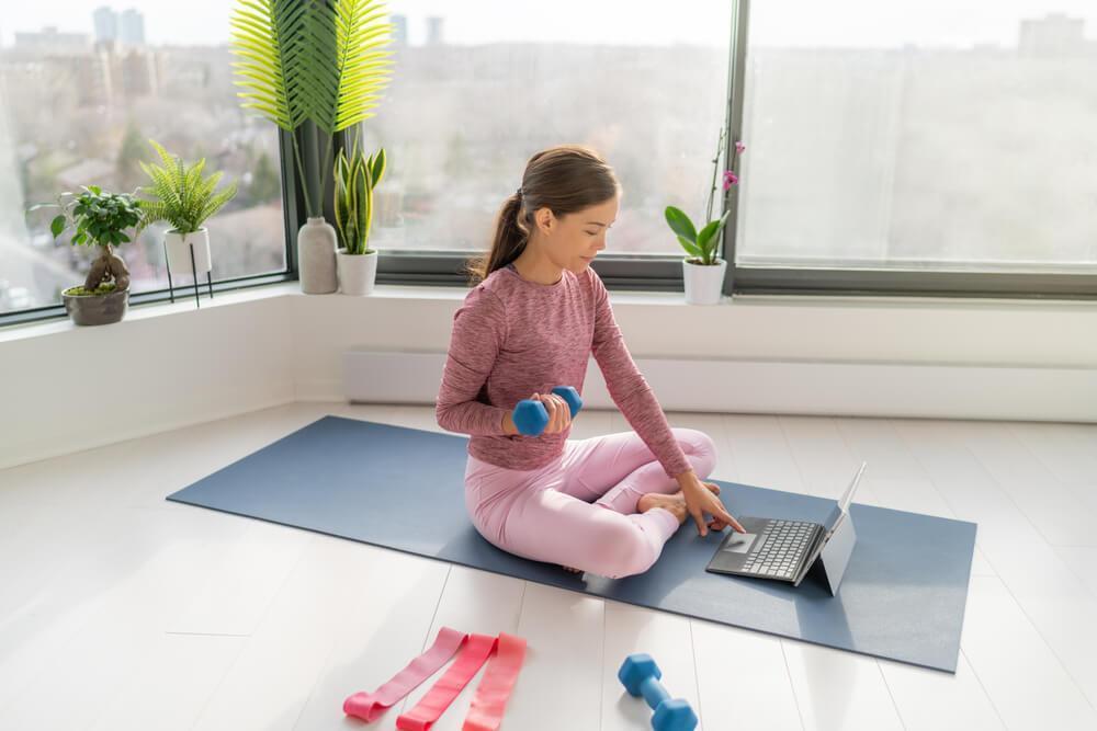 woman using dumbbells at home