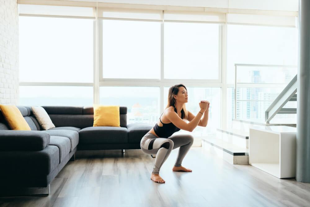 Woman doing squats at home