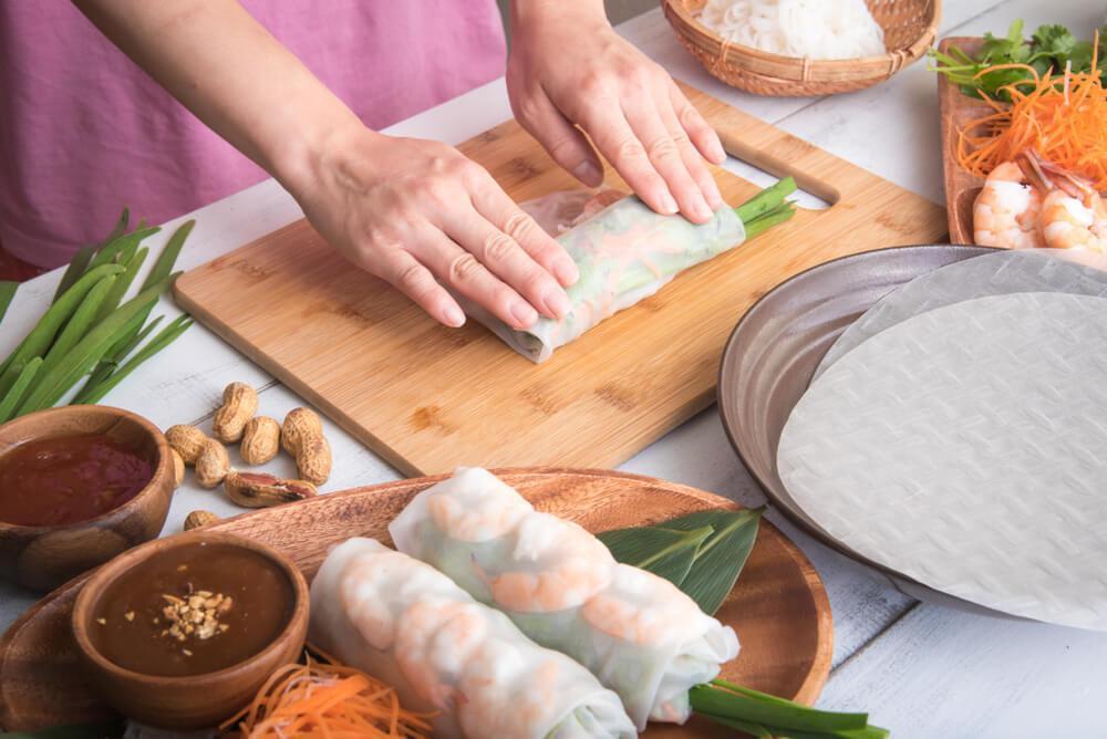 Woman making summer rolls