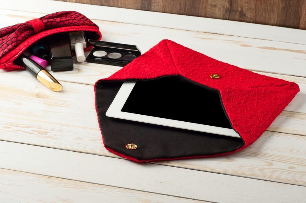 Red purse with tablet and makeup