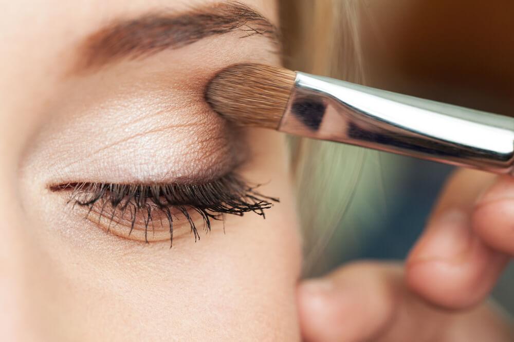 Woman applying eye makeup