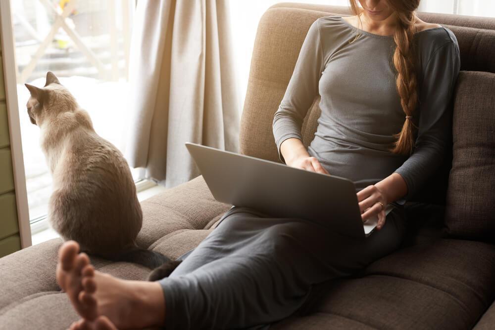 Woman looking at laptop on sofa