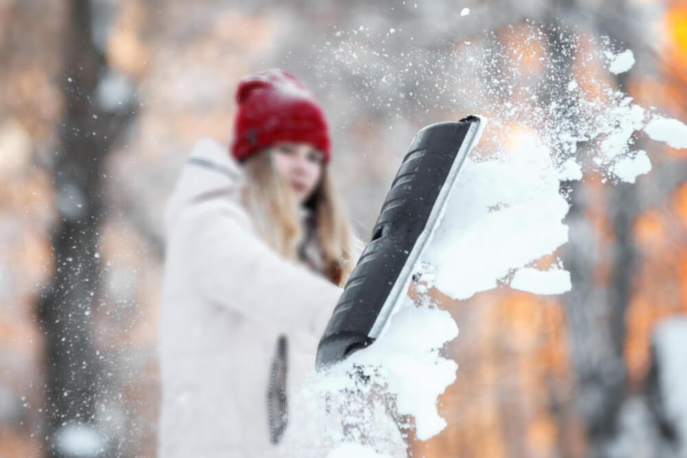 Woman shovelling snow