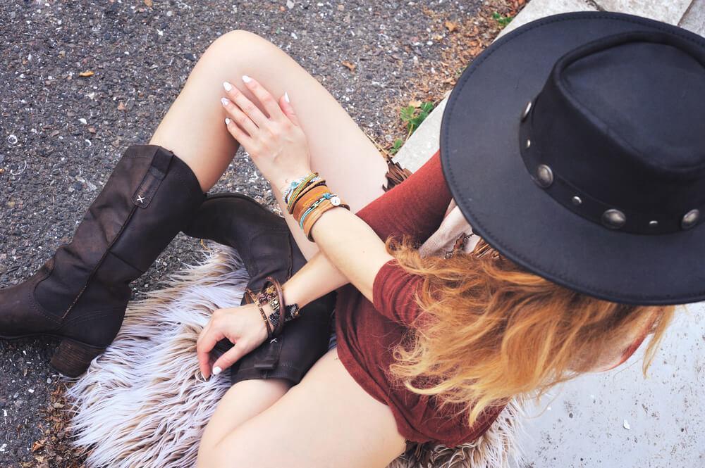 Woman sitting on floor wearing bracelets