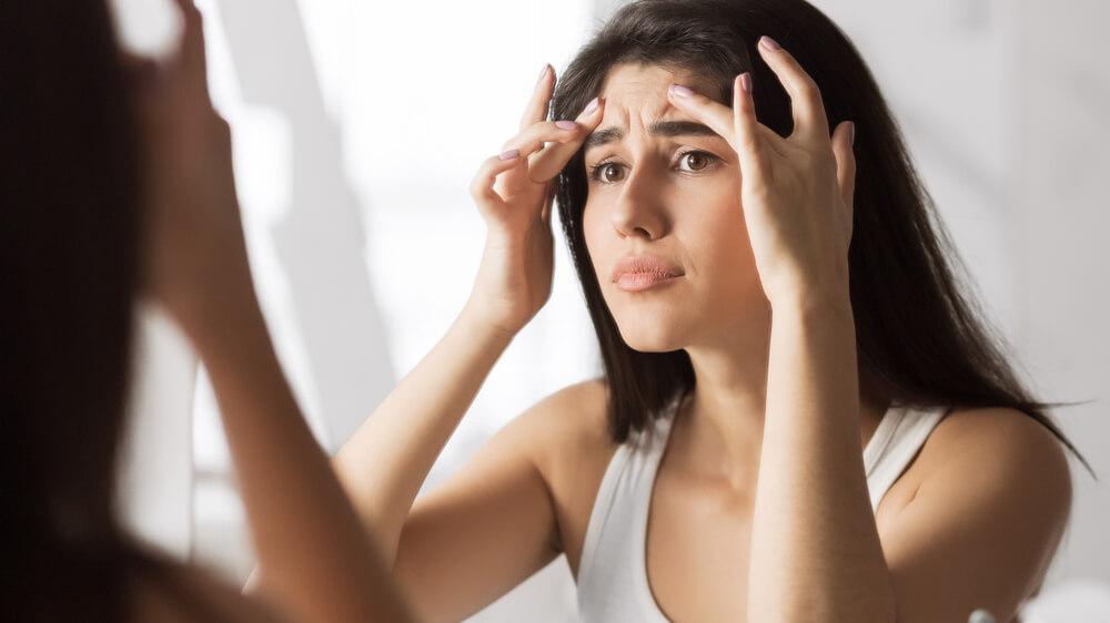 Woman squeezing forehead