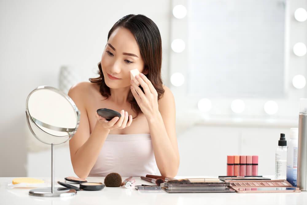 Woman applying foundation