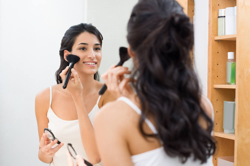 woman looking in mirror