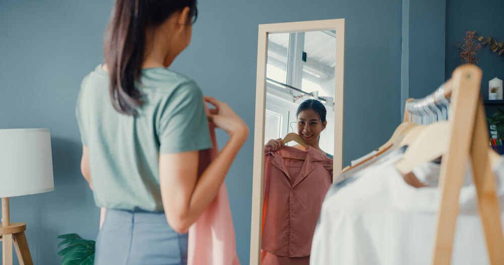 girl holding shirt